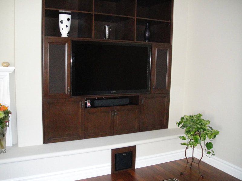 TV cabinet built-in to the wall next to a fireplace
